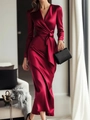 Detail of the deep V-neck and elegant waist tie knot on a luxurious red satin dress - S / Dresses / Red