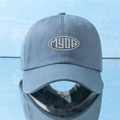 Close-up of MYDB embroidered logo on a light blue cotton baseball cap with ventilation holes - Adjustable / Blue