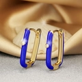 Golden U-shaped earrings with blue enamel and sparkling zircon on satin background - Sapphire Blue
