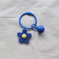 Handmade knitted blue flower keychain with a round bell charm on a metal ring - Sapphire Blue