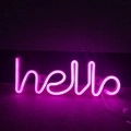 Detail of pink LED neon sign showing the hello script with smooth glow against dark wall - Pink Hello Integrated
