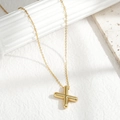 Minimalist gold necklace featuring a polished 3D X-shaped pendant on a slim chain link - Letter X