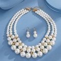 Three-layer pearl necklace and drop earrings set with gold finish on blue background - 3-Row Pearl Gold-Tone Infinity Necklace Earring Set