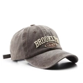 Detailed close-up of 3D Brooklyn 1947 embroidery on washed dark gray cotton baseball cap - Adjustable / Coffee