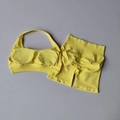 Flat lay of bright yellow yoga set featuring halter bra and high waist scrunch butt shorts - S / Light Yellow