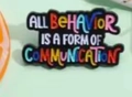 Black enamel pin with colorful text reading All Behavior Is A Form Of Communication - Quote Text Pin