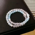 Detailed shot of white crystal and light blue beads bracelet with silver floral spacers - Aquamarine Carved Spacer Style (26#)