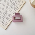 Detail view of square matte hair claw in lotus pink on a minimalist white surface - Matte Purple