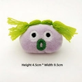 Detail shot of purple plush brooch with green hair, measuring 4.5cm high and 9.5cm wide - Green Hair Ugly Girl