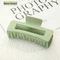 Pea green matte large square hair claw clip for thick hair displayed on white ceramic tray - Bean Green