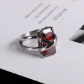 Cross-style stainless steel ring featuring a large rectangular red ruby stone inlay - US Size 9