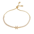 Detailed view of golden adjustable bracelet with Pisces charm and white zircon stones - Gold Pisces
