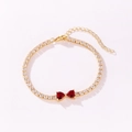 Close-up of elegant gold tennis bracelet with red heart-shaped crystals - Heart to Heart Style (Red Rhinestone) / Gold