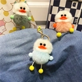 Detailed view of plush duck keychains in mint green, peach pink, and sky blue on denim - Sky Blue