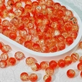 Macro shot of 10mm orange glass beads with golden crackle texture for DIY jewelry - Golden Yellow (H9)