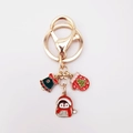 Close-up of Christmas keychain with enamel penguin, red glove, and green bell charms - Christmas Penguin Style (4911922231895)