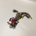 3D printed poseable T-Rex skeleton model with vibrant rainbow gradient metallic finish - Red Yellow Blue
