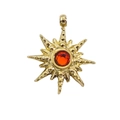 Close-up of a 14k gold starburst pendant with a ruby-red zircon center stone - Orange Rhinestone