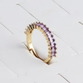Detailed macro view of gold-plated adjustable ring featuring channel-set purple zircons - Adjustable Open / Purple