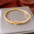 Detail of 18K gold-plated bangle featuring a pave zircon cross and hollow peace sign - Gold