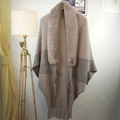 Detail of gradient knit shawl featuring a thick faux fur collar and long fringe trim - Patchwork Khaki