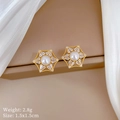 Macro detail of gold hexagon star earrings with white pearl and sparkling zircon stones - Star Silver Earring Post Stud Earrings (A128) / Gold