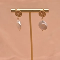 Elegant gold twisted disc earrings with baroque white pearls on a minimalist T-stand - Lollipop Baroque Earrings