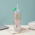 Detailed view of festive Christmas tumbler with straw and green tree ornament lid - Style 6 (Light Blue/Penguin)