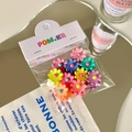 Matte candy-colored daisy flower hair clips in a colorful set on a display card - Daisy