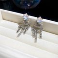 Detailed view of silver Christmas tree earrings with sparkling tassels in a jewelry box - Silver (Silver Pin)