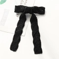 Macro detail of hand-beaded black chevron bow hair clip with long elegant tassels - Black Leaf Beaded Bow Clip