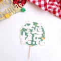 Detail of round green Merry Christmas cake topper with festive wooden pick and star motifs - Style M Merry Christmas