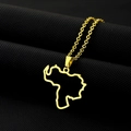 Detail of gold Venezuela map pendant with O-chain on textured dark fabric background - Hollow Map / Gold