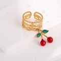 Close-up of cherry pendant ring with red beads and green enamel leaves on white stone - Multi-layer Combo Style (J-20014)