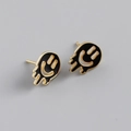 Close-up of gold s925 silver stud earrings with black melting smiley face enamel - 925 Silver / Black (Gold)