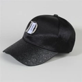 Close-up of rhinestone D logo and woven label on a black denim baseball cap - Style 25-Black Satin Sequin Label D