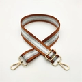 Detail of adjustable woven bag strap in brown and white with gold metal lobster clasps - Brown