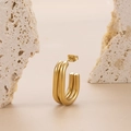 Polished gold double-loop U-shaped earrings on minimalist stone texture background - Gold Double Ring U-Shaped Hoop Earrings