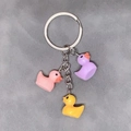 Three colorful resin duck charms on a silver keychain for bags and backpacks - Mixed 3 Pcs Set / Purple Pink Yellow
