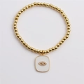 Detail of gold beaded stretch bracelet with white enamel evil eye charm and zircons - 0470 Evil Eye Rectangle