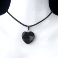 Polished black obsidian heart pendant necklace with braided cord on mannequin - Black Agate