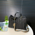 Black quilted puffer tote bag with decorative jacquard strap and gold-tone hardware - Black