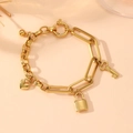 Detail of gold chain bracelet with heart, lock, and key charms on a neutral background - Heart Lock Style (I505) / Gold