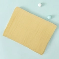 Folded yellow double-layer cotton gauze swaddle blanket on a light blue background - Light Yellow