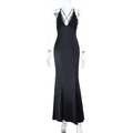 Detail of elegant black long dress with deep V-neckline and intricate lace trim features - XS / Black