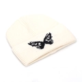 Creamy white knitted beanie with black butterfly jacquard and cuffed design for winter - White
