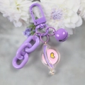 Close-up of purple metal spring clasp with a chain and clear pink planet charm - 5126-10 Purple Planet