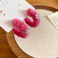 Nahaufnahme der rosafarbenen Plüsch-Ohrringe mit silbernen Schneeflocken für den Winter - 925 Silberstecker / Silber-Ohrstecker - Rosa