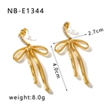 Detail of 18K gold plated bow earrings with sparkling cubic zirconia on white background - 18K Gold