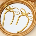 Elegant gold bow earrings with a snake chain texture displayed on a mirror surface - French Vintage Mirror Bowknot Style (E01282G)